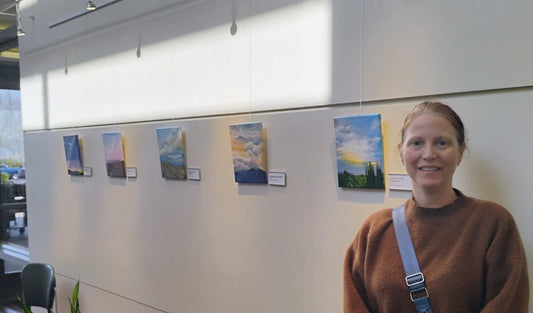 Artist, Cecilia stands next to art collection, VIEWS, on display at the Ronald H Library in Temecula
